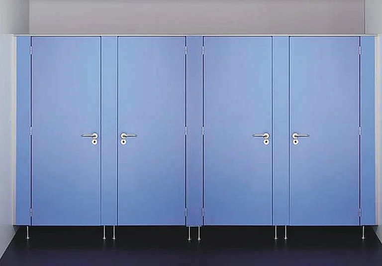 Vier blaue WC-Kabinentüren in einer Reihe mit silbernen Türklinken und Metallstützfüßen